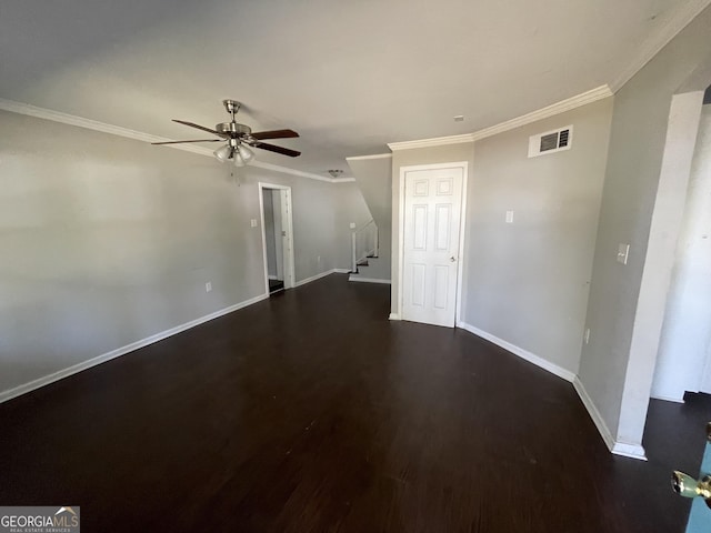 empty room with ceiling fan, dark wood-type flooring, and ornamental molding