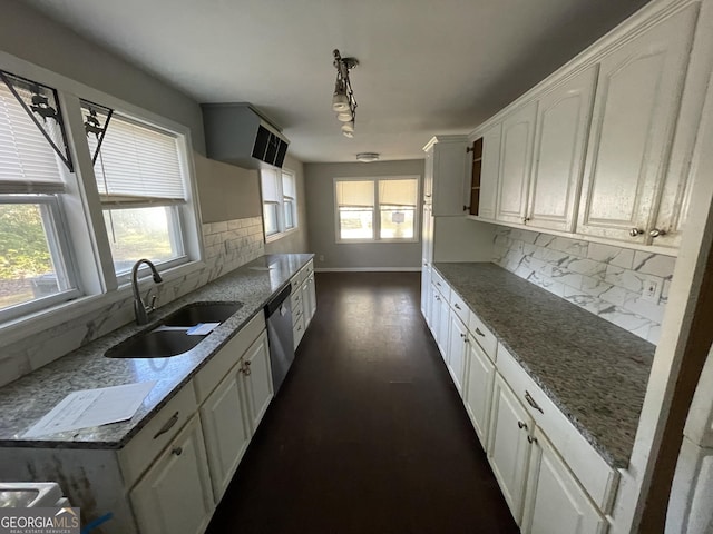 kitchen featuring dishwasher, dark stone counters, sink, tasteful backsplash, and white cabinetry