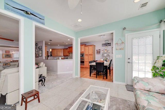 tiled living room with ceiling fan