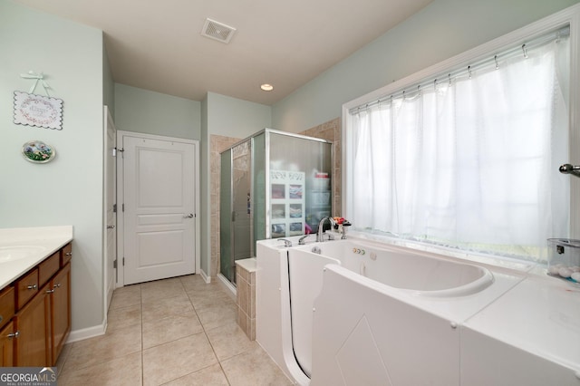 bathroom with tile patterned floors, vanity, and shower with separate bathtub