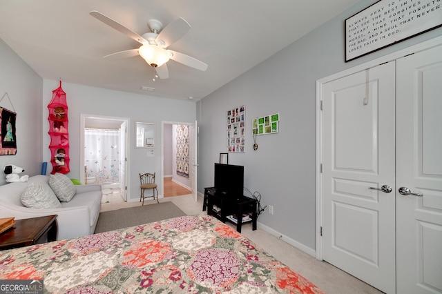 carpeted bedroom featuring ceiling fan and a closet