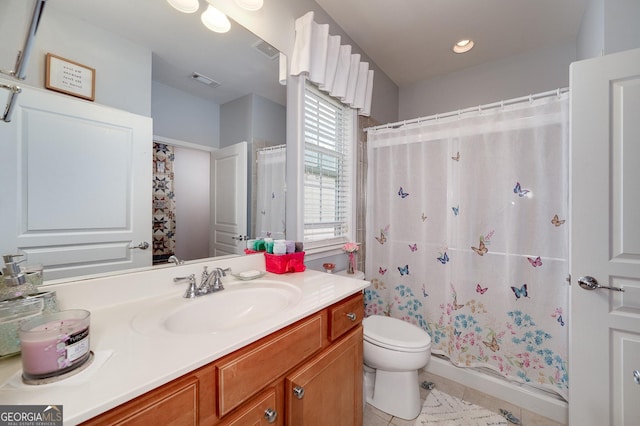 bathroom featuring tile patterned floors, walk in shower, vanity, and toilet