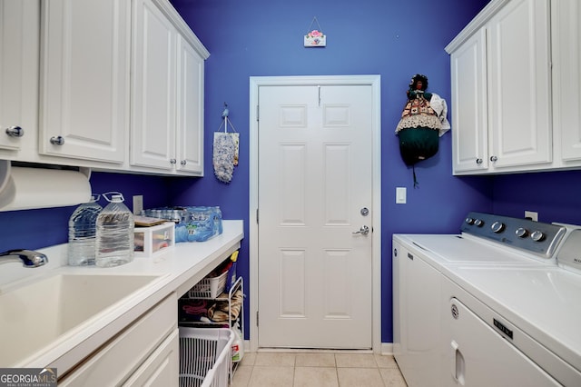 laundry room with washer and dryer, light tile patterned floors, cabinets, and sink