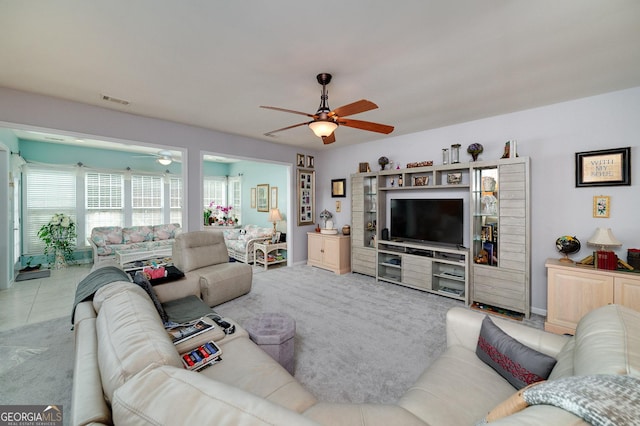 living room featuring ceiling fan and light colored carpet