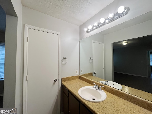 bathroom featuring vanity and a textured ceiling