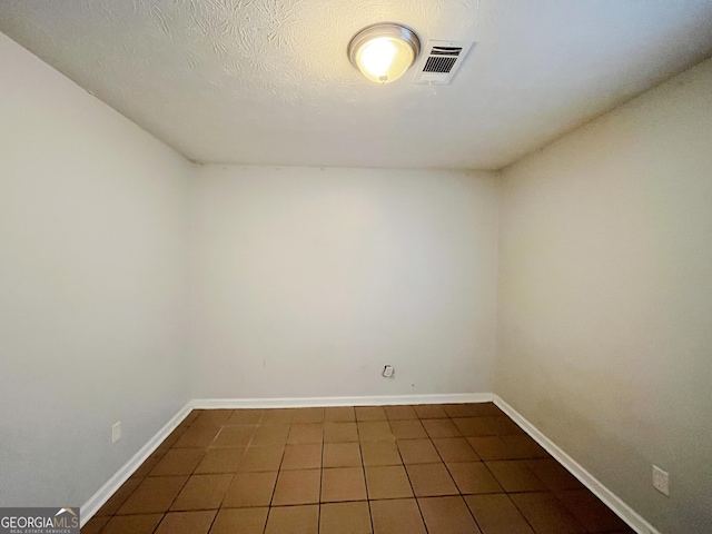 empty room featuring a textured ceiling