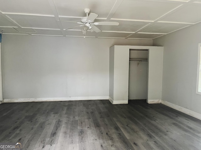 unfurnished bedroom with ceiling fan, a closet, and dark wood-type flooring