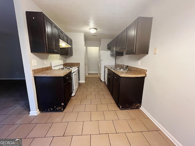 kitchen featuring white appliances, sink, and light tile patterned floors