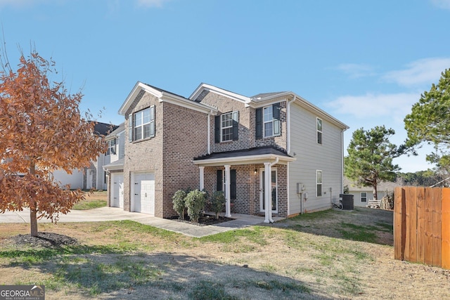 view of front facade featuring central AC unit, a garage, and covered porch