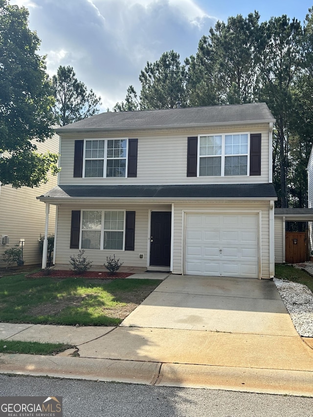 front facade with a garage and a front yard