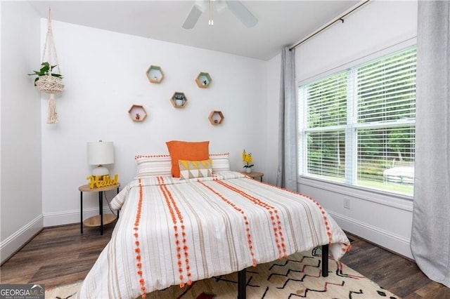 bedroom with ceiling fan and dark wood-type flooring