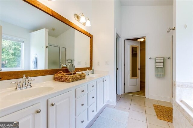 bathroom featuring tile patterned flooring, shower with separate bathtub, and vanity