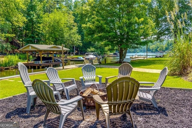 view of patio featuring a water view and a fire pit