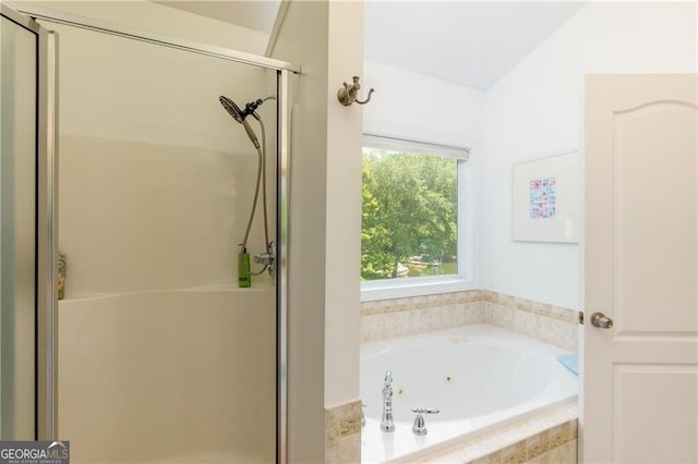 bathroom featuring plus walk in shower and vaulted ceiling