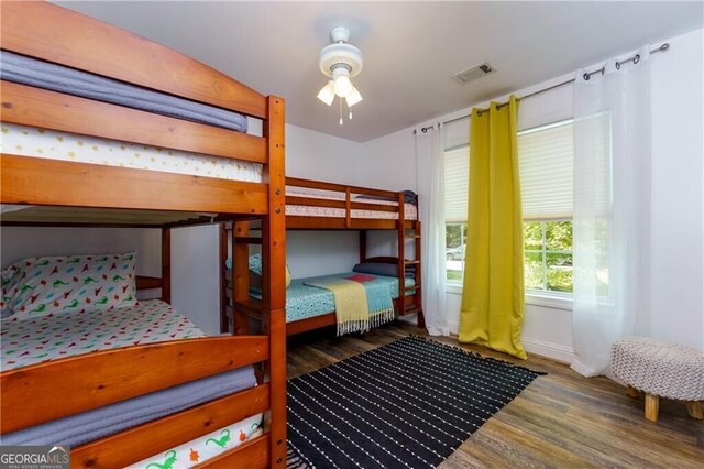 bedroom with ceiling fan and dark wood-type flooring