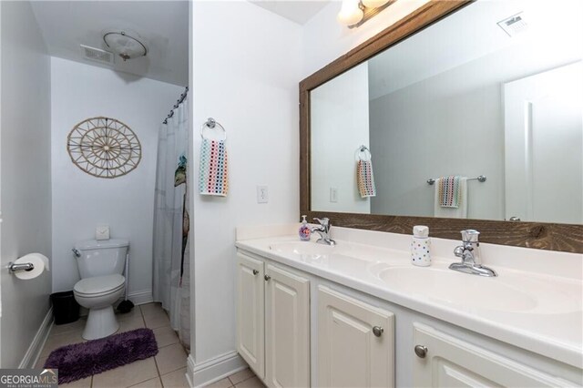 bathroom featuring toilet, vanity, and tile patterned floors