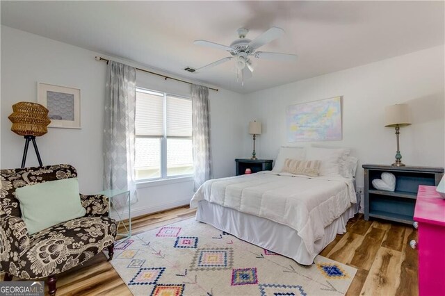 bedroom featuring hardwood / wood-style flooring and ceiling fan