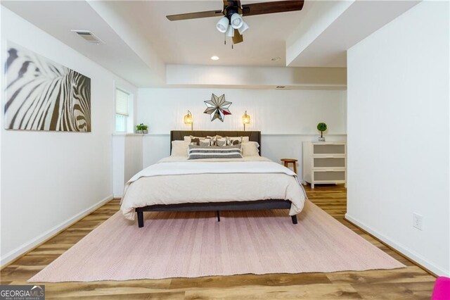 bedroom featuring hardwood / wood-style floors and ceiling fan