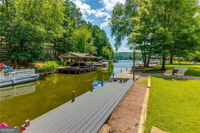 view of dock with a water view and a yard