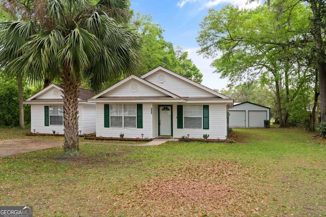 view of front of property featuring a garage, an outdoor structure, and a front yard