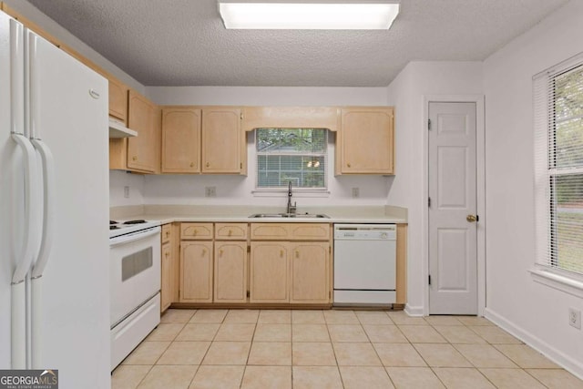 kitchen featuring light brown cabinetry, white appliances, a textured ceiling, and sink