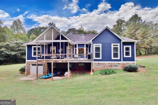 rear view of house featuring a yard, a garage, and a deck