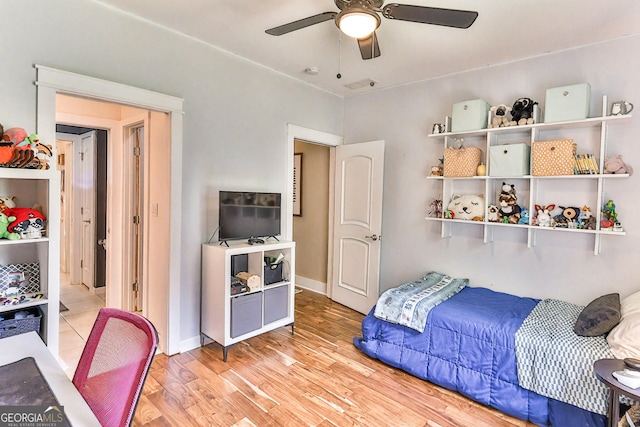 bedroom with light hardwood / wood-style floors and ceiling fan