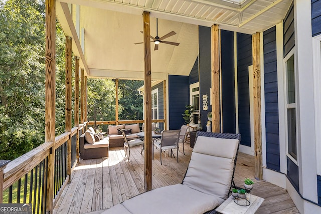 deck with outdoor lounge area and ceiling fan