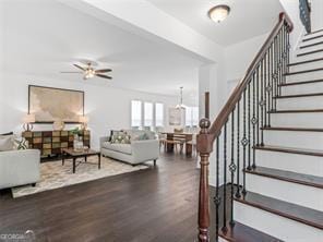 living room with ceiling fan and dark hardwood / wood-style flooring