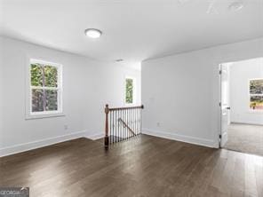 spare room with dark hardwood / wood-style floors