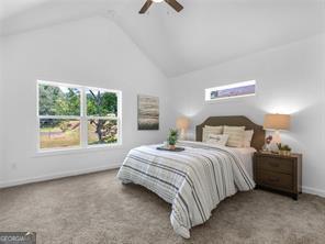 bedroom featuring carpet flooring, ceiling fan, and vaulted ceiling