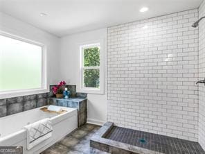 bathroom featuring separate shower and tub