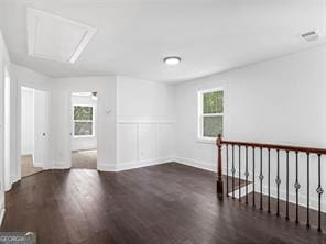 spare room featuring dark hardwood / wood-style floors and a wealth of natural light