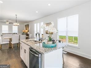 kitchen with sink, pendant lighting, dishwasher, white cabinetry, and an island with sink