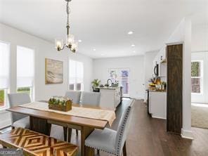 dining space featuring dark hardwood / wood-style flooring and a notable chandelier