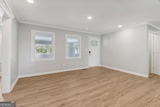 foyer featuring light hardwood / wood-style floors and crown molding