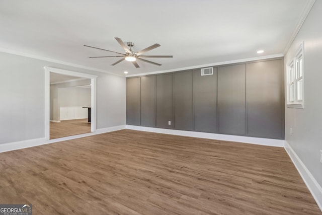 unfurnished bedroom with wood-type flooring, ceiling fan, and ornamental molding