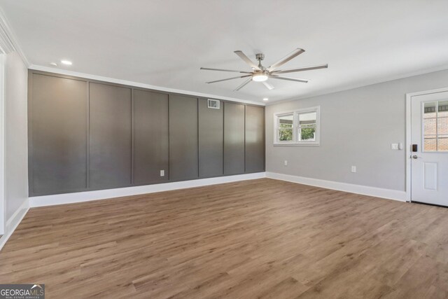 spare room featuring ceiling fan, light hardwood / wood-style floors, and crown molding