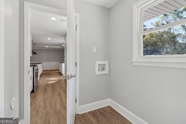 clothes washing area with hookup for a washing machine and hardwood / wood-style floors