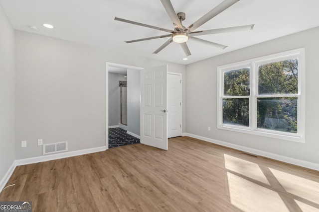 unfurnished bedroom with ceiling fan and light hardwood / wood-style floors