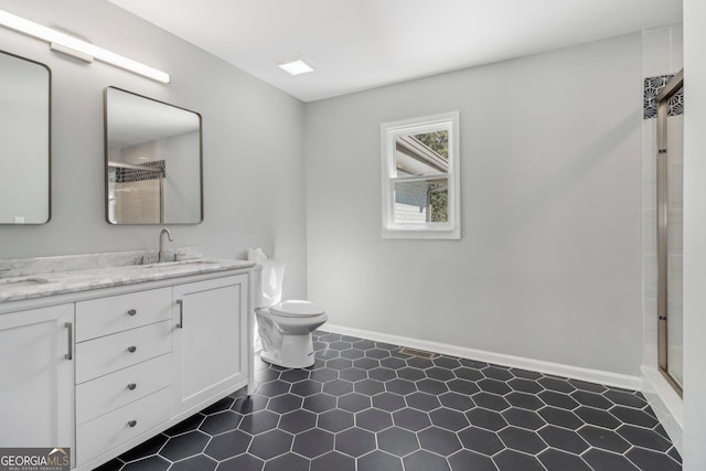 bathroom featuring vanity, toilet, and a shower