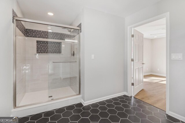 bathroom featuring tile patterned flooring and a shower with door