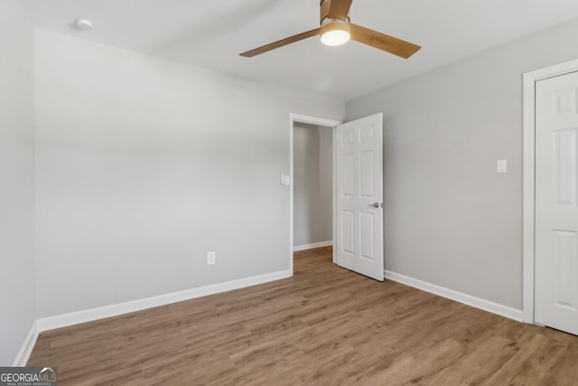 empty room featuring hardwood / wood-style floors and ceiling fan