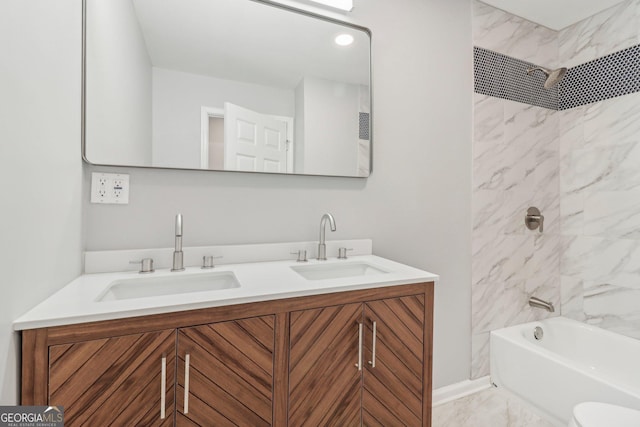 bathroom featuring vanity and tiled shower / bath combo