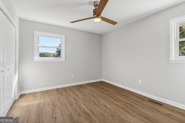 unfurnished room featuring ceiling fan and hardwood / wood-style flooring