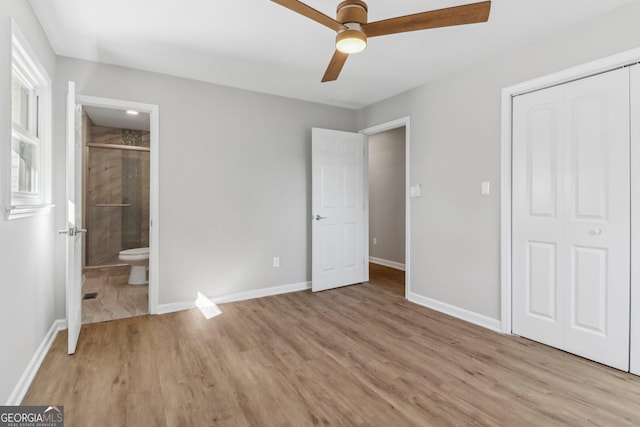 unfurnished bedroom featuring a closet, ensuite bathroom, ceiling fan, and light hardwood / wood-style floors