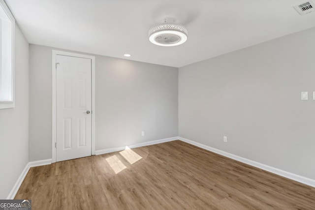 empty room with hardwood / wood-style floors