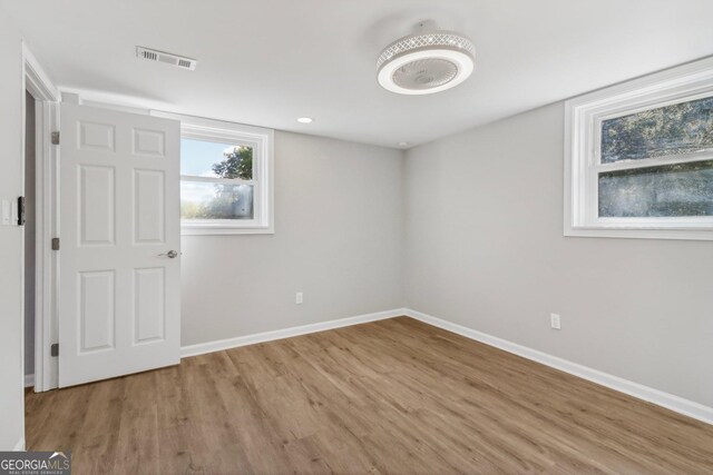 empty room with light hardwood / wood-style flooring