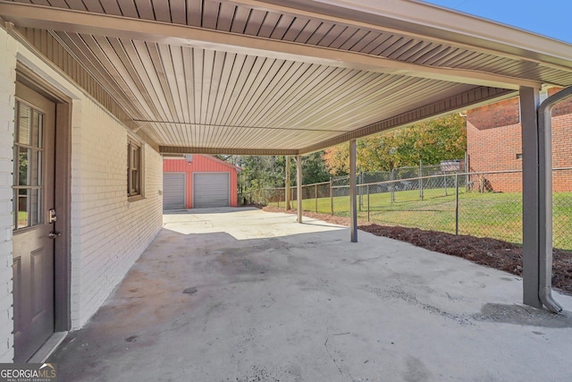 view of patio / terrace with an outbuilding, a garage, and a carport