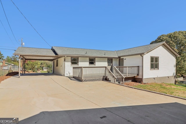 ranch-style home featuring a deck and a carport